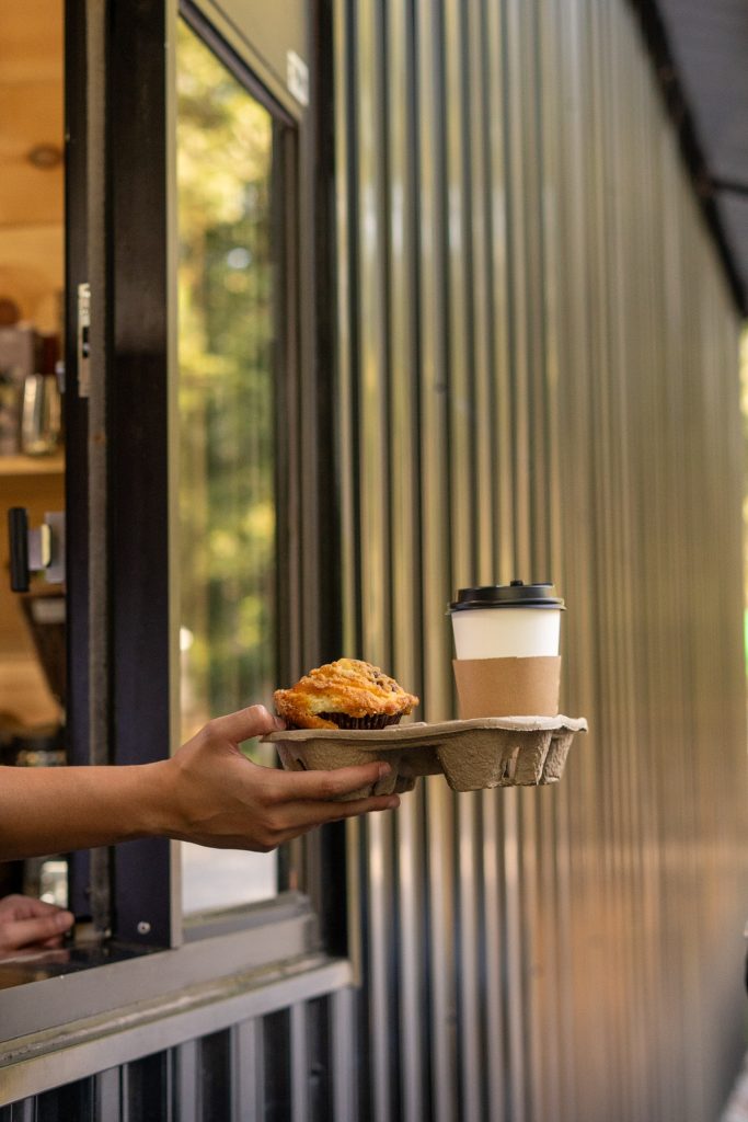 A coffee and a pastry passed out through the drive-thru window at Cafe Pilates